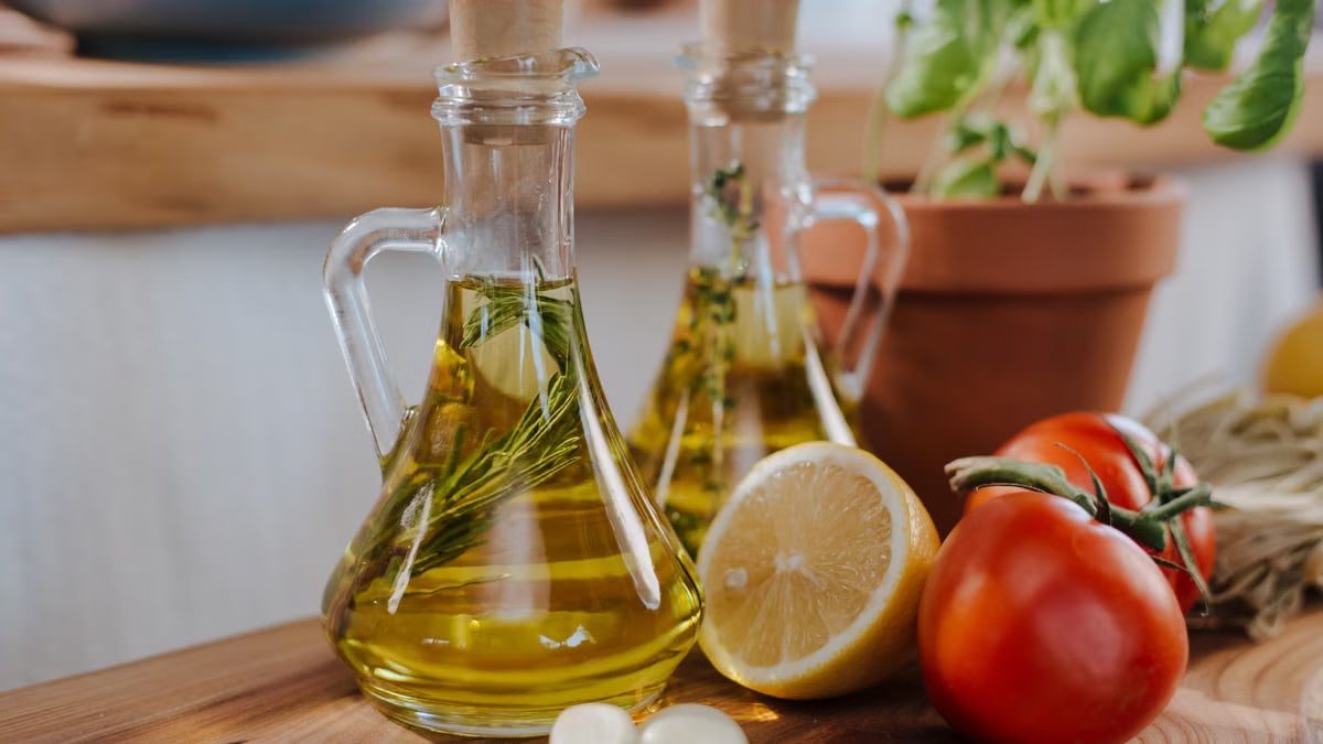 Close-up of fresh ingredients for Italian cooking featuring olive oil and basil.